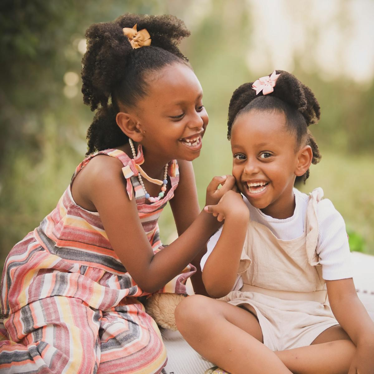 Joyful sisters laughing in a park setting